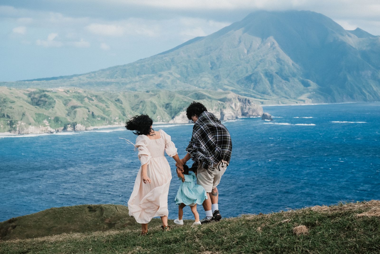 A Filipino family sharing a moment overlooking the coast